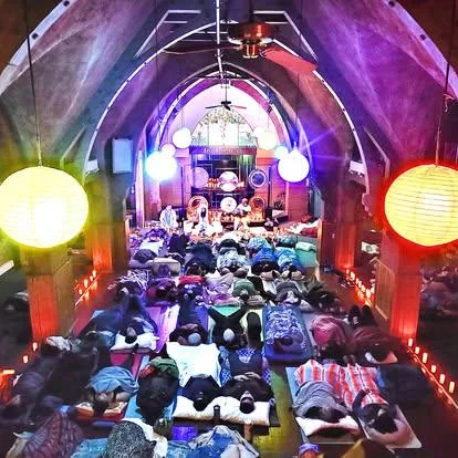 Sound bath participants in the illuminated Chapel of the Flowers