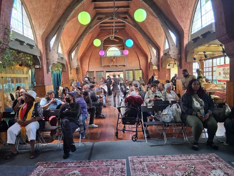 Community Survival Program gathering inside the Chapel of the Flowers
